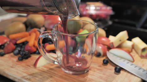 Fresh-juice-being-poured-into-glass-from-juicer