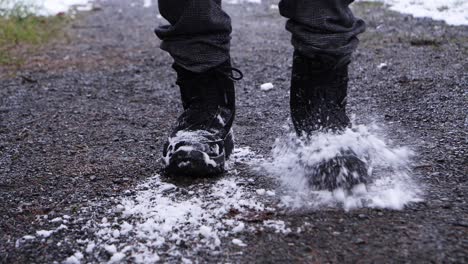 Close-up-shot-of-person-Shake-stamping-boots-of-snow-outdoors-during-snowy-winter-day