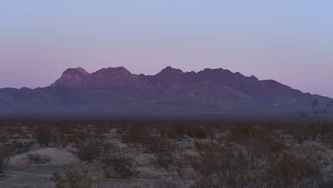 Pink-Glow-on-Mountains-Fades-Quickly-as-Sun-Sets-in-the-Mojave-Desert,-Timelapse