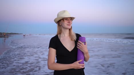 Beautiful-Lady-Wearing-Summer-Hat-Holding-A-Purple-Thermos-Flask-At-The-Beach-Of-Monte-Hermoso,-Buenos-Aires,-Argentina