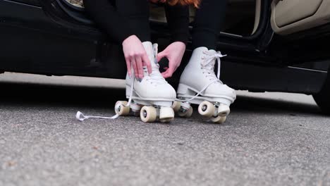Close-Up-of-Female-Hands-Tie-Down-Shoestring-on-Roller-Skates,-Slow-Motion