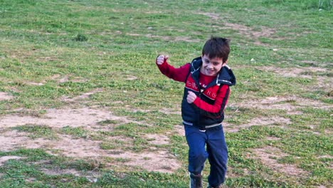 Slow-motion-of-cute-caucasian-boy-running-in-the-fields-towards-camera-120fps