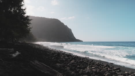 Blue-Pacific-Ocean-waves-break-on-black-sand-beach