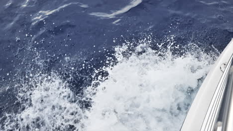Top-down-view-of-boat's-wake-as-it-moves-through-deep-ocean