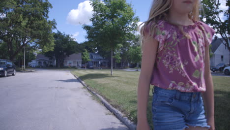 Young-Blonde-girl-walking-past-camera-on-way-to-school