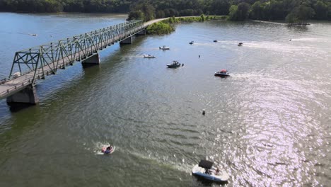 Several-boats-crossing-under-a-bridge-in-a-no-wake-zone