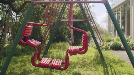 Medium-wide-shot-of-a-swingset-on-a-sunny-spring-day