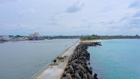 Aerial-drone-view-along-Sans-Souci-pier-with-breakwater,-Santo-Domingo