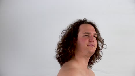 closeup-of-shirtless-young-man-turned-to-the-left-and-shaking-his-hair-on-white-background