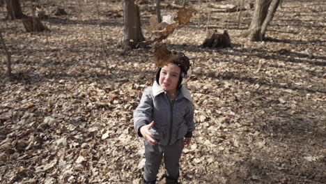 Cute-toddler-boy-throwing-leaves-in-the-air