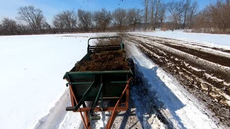 Old-Manure-Spreader-Working-On-A-Winter-Field-Fertilizing-The-Soil-In-Southeast-Michigan