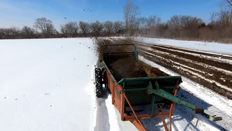 Pulled-Fertilizing-Machine-Running-On-Snowscape-Agricultural-Farmland-In-Southeast-Michigan