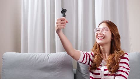 Girl-doing-vlog-in-her-house-holding-camera-in-hand