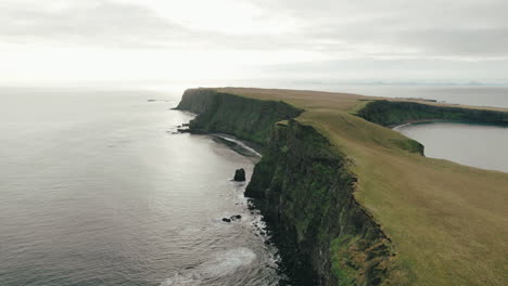 Reverse-aerial-dolly-along-cliffs-of-Grimsey-Island-in-Arctic-Circle-near-Iceland