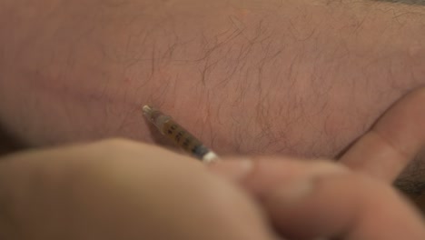 Heroin-addict-injecting-heroin-using-syringe