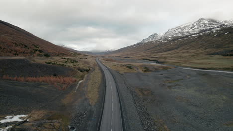 Car-driving-empty-stretch-of-highway-through-Iceland-river-valley