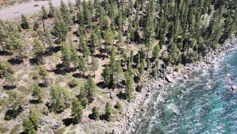 Drone-flying-over-rough-waves-near-zephyr-cove-Nevada-while-the-drone-fly's-up-and-over-Highway-50