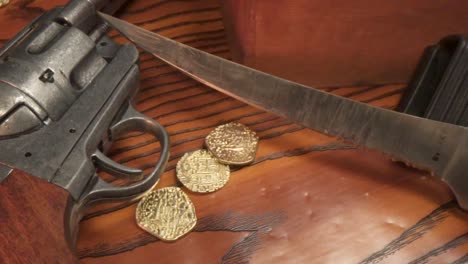 Gold-coins-falling-onto-wood-with-gun-and-knife