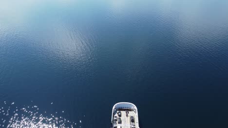 Car-and-passenger-ferry-MF-Oppedal-entering-into-frame-from-birdseye-perspective---Beautiful-sunny-day-with-calm-sea-connecting-road-E39-between-Oppedal-and-Lavik---Static-aerial-Norway