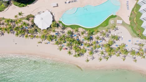 Aerial-View-Of-Swimming-Pool-At-Marbella-Hotel-By-White-Sand-Beach-At-Juan-Dolio,-Dominican-Republic