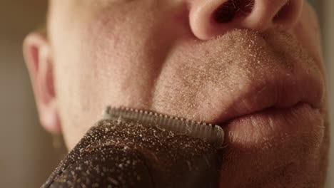 SLOW-MOTION,-MACRO-WIDE,-a-man-shaving-with-clippers