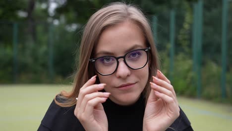 Close-Up-of-Young-Woman-Wearing-Glasses-and-Looking-at-Camera-With-a-Smile,-Slow-Motion-Full-Frame