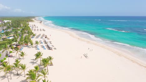 Drone-view-along-waterfront-Punta-Cana-Hard-Rock-resort-and-sandy-beach,-Dominican-Republic