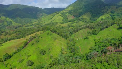 Aerial-shot-of-idyllic-and-lush-green-mountain-landscape-during-summertime-on-Dominican-Republic