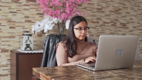 a-young-latinx-woman-with-laptop