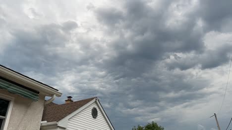 Time-lapse-of-storm-clouds-over-house