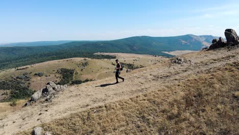 Male-Hiker-Walking-Down-The-Mountain-In-Romania-At-Summer
