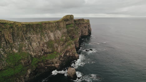 Seabirds-fly-near-sheer-cliff,-Grimsey-Island,-Arctic-Circle