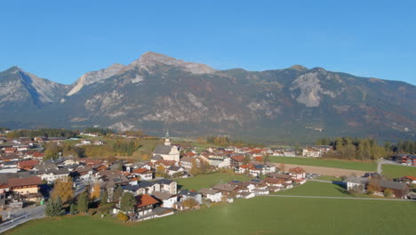 Breathtaking-morning-flight-to-Church-in-village-of-Tirol-Austria,-drone-push-in