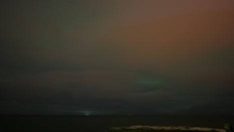 Timelapse-of-aurora-borealis-lighting-up-starry-sky-and-low-clouds-in-Iceland