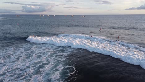 Beautiful-scenary-of-surfers-catching-waves-with-amazing-view-in-the-back-in-Hawaii