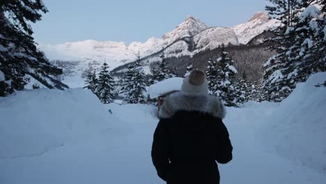 Kamera-Folgt-Person-In-Winterkleidung,-Die-Auf-Schnee-Spazieren-Geht,-Alpine-Landschaft