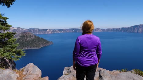A-tourist-looks-at-Wizard-Island-from-Discovery-Pass-in-Crater-Lake-National-Park