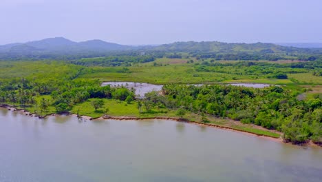 Sabana-de-la-Mar-coast-and-lush-vegetation-seen-from-drone,-Dominican-Republic