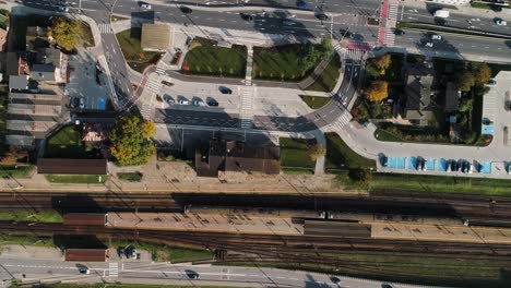 Top-down-view-over-a-high-traffic-road-and-a-train-railway,-Reda-town-in-Poland