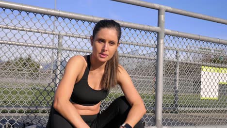 Fatigued-athletic-woman-sitting-resting-after-run