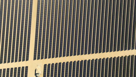 Birdseye-aerial-view-over-thousands-of-solar-panels-generating-electricity-in-the-Californian-Desert