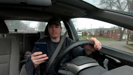 Irresponsible-driver-potentially-breaking-the-law-by-texting-on-his-phone-whilst-driving