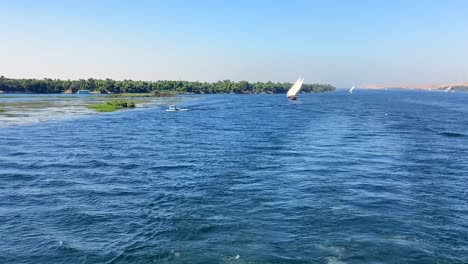 Luxurious-sail-boats-sailing-on-Nile-River-on-beautiful-blue-sky-summer-day