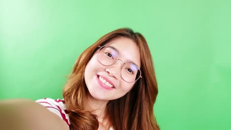 The-portrait-of-a-selfie-Asian-woman-with-eyeglasses-is-smiling-with-laughter-being-positive-emotions-on-video-call-online