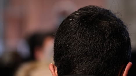 Man-with-some-white-hairs-in-the-top-of-the-back-of-his-head,-indoors-back-shot-in-4k