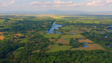 Panoramic-View-On-Lush-Green-Vegetation-Surrounding-Hatillo-Dam-In-Dominican-Republic---aerial-drone-shot