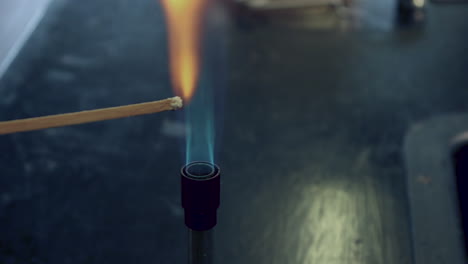 Close-up-of-blue-bunsen-burner-flame-followed-by-barium-flame-test-burning-yellow