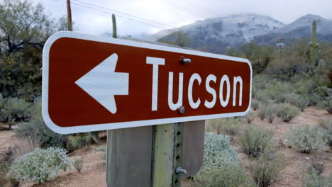 Tucson-welcome-highlight-sign-board,-with-dry-landscape-green-bushes-at-winter-season
