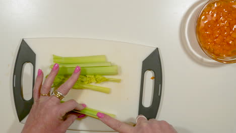 Overhead-view-of-a-woman's-hands-chopping-celery