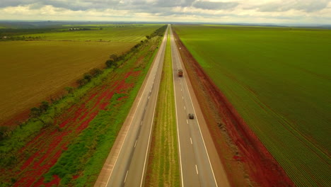 Static-aerial-shot-of-a-quiet-highway-passing-through-the-rural-countryside-in-South-America